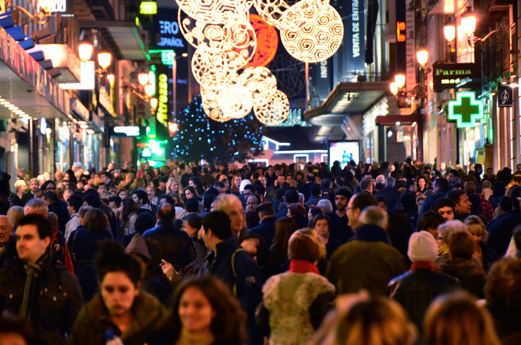 "Puerta Del Sol holiday shopping crowds. I think this was about 10:45pm." by msenese is licensed under CC BY-NC-ND 2.0.