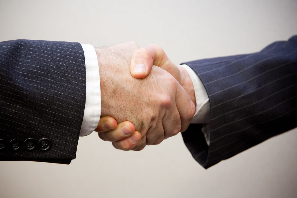 "Handshake - 2 men" by flazingo_photos is licensed under CC BY-SA 2.0.